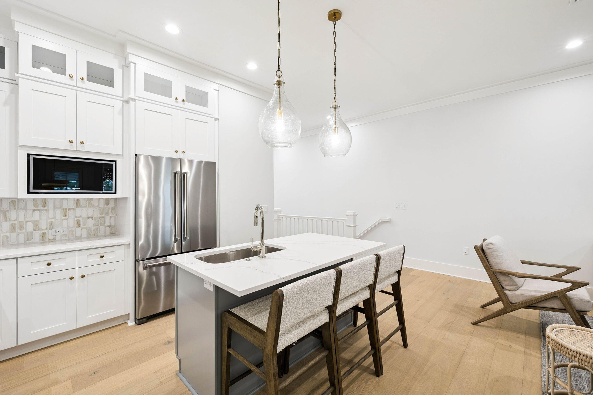 45 Grove Townhomes Place, Unit 105 Santa Rosa Beach, FL 32459 - Photo 12 of 36 a kitchen with stainless steel appliances kitchen island granite countertop a table chairs and a refrigerator