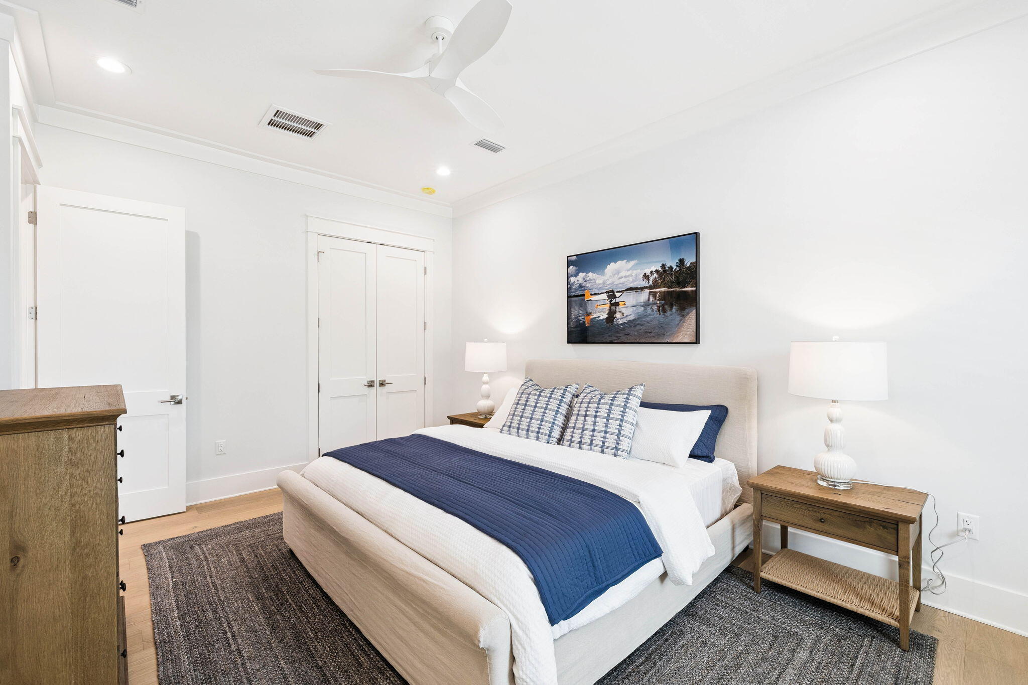 45 Grove Townhomes Place, Unit 105 Santa Rosa Beach, FL 32459 - Photo 18 of 36 a spacious bedroom with a bed and a lamp