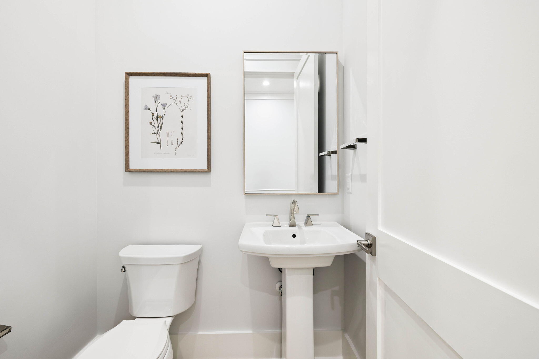 45 Grove Townhomes Place, Unit 105 Santa Rosa Beach, FL 32459 - Photo 23 of 36 a bathroom with a sink mirror and toilet
