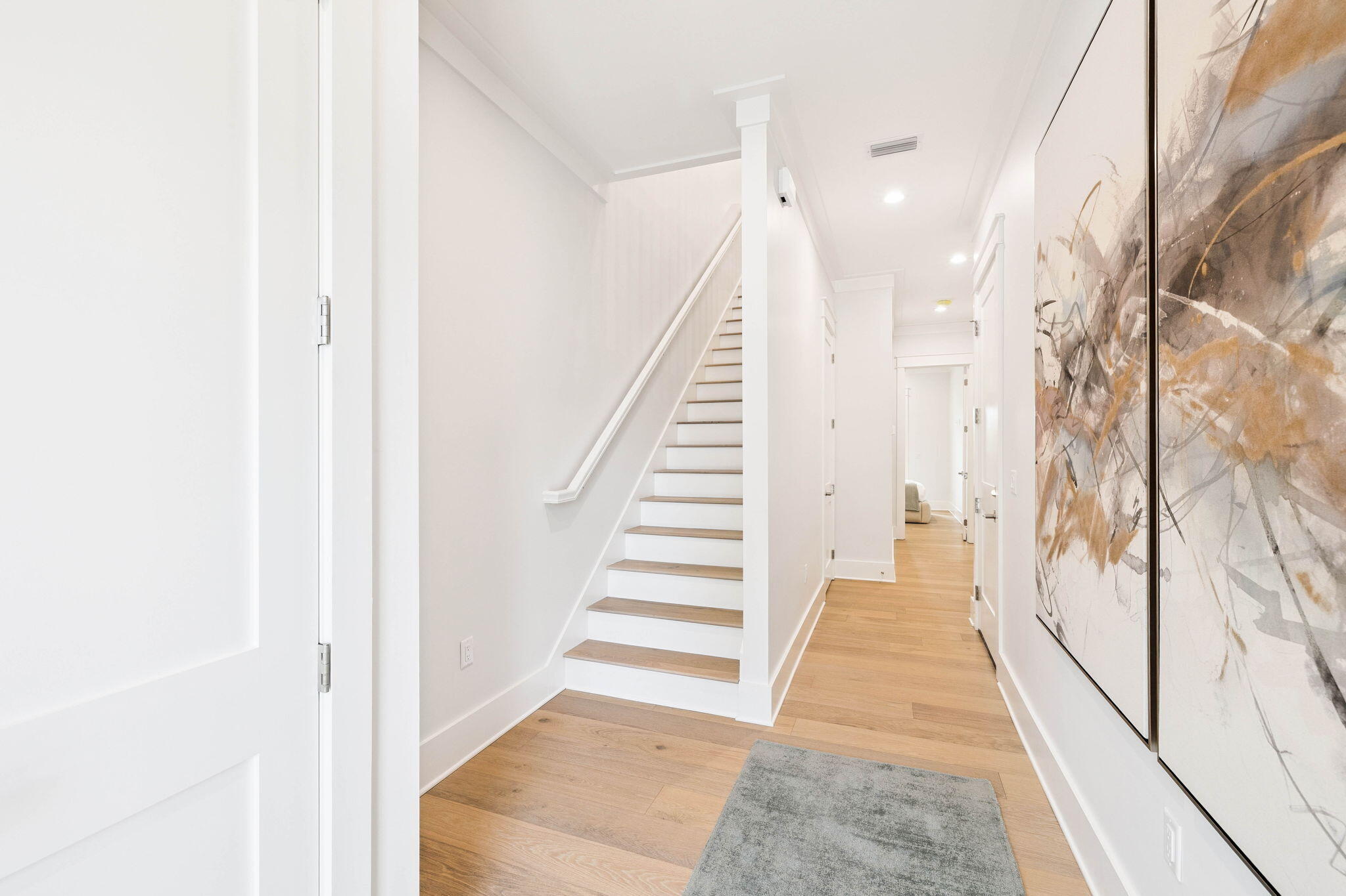 45 Grove Townhomes Place, Unit 105 Santa Rosa Beach, FL 32459 - Photo 7 of 36 a view of a hallway with wooden floor and stairs
