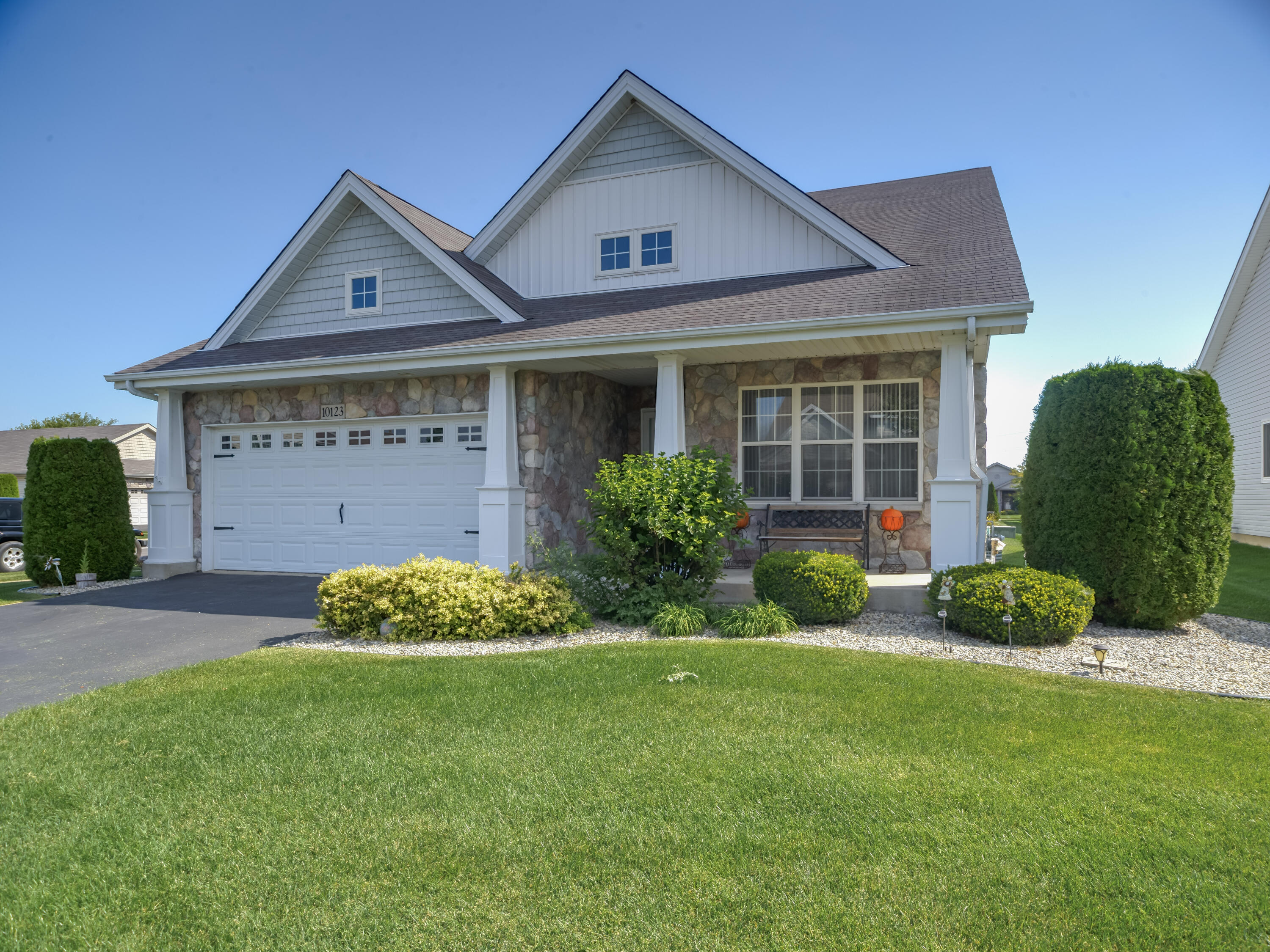 10123 Azalea Drive Crown Point, IN 46307 - Photo 1 of 32 a front view of a house with a garden and plants