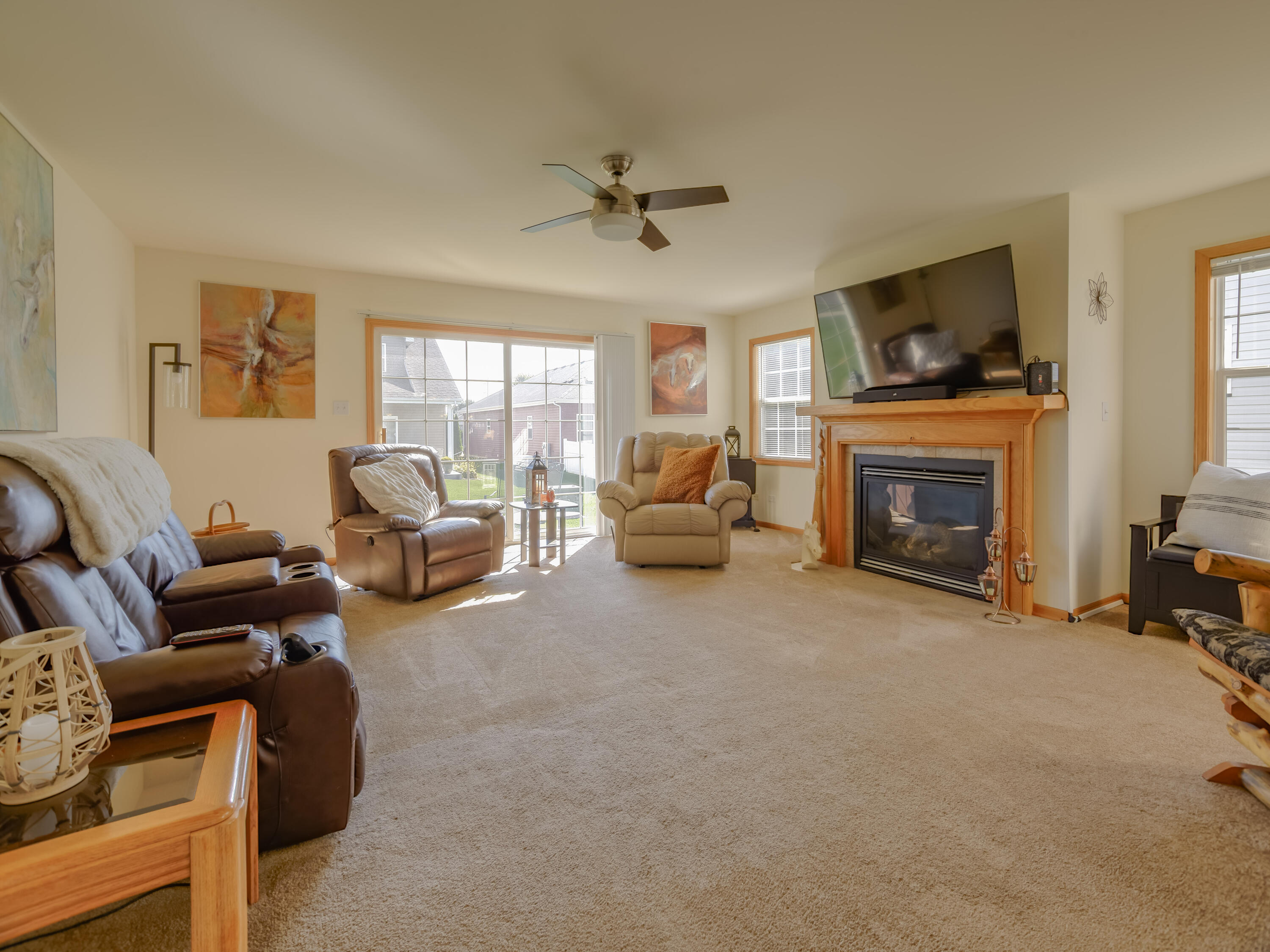 10123 Azalea Drive Crown Point, IN 46307 - Photo 17 of 32 a living room with furniture a flat screen tv and a fireplace