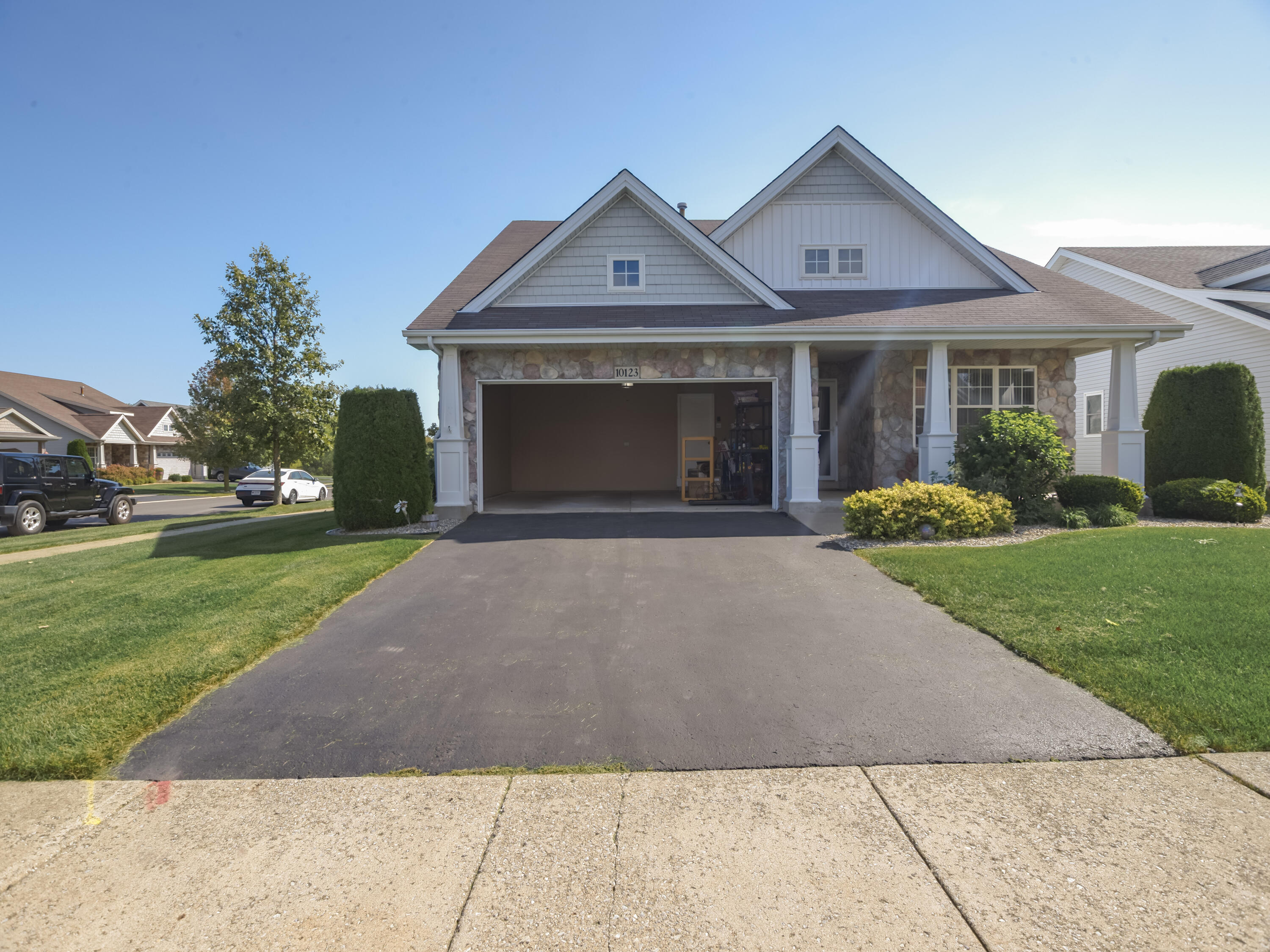 10123 Azalea Drive Crown Point, IN 46307 - Photo 2 of 32 a front view of a house with garden and trees
