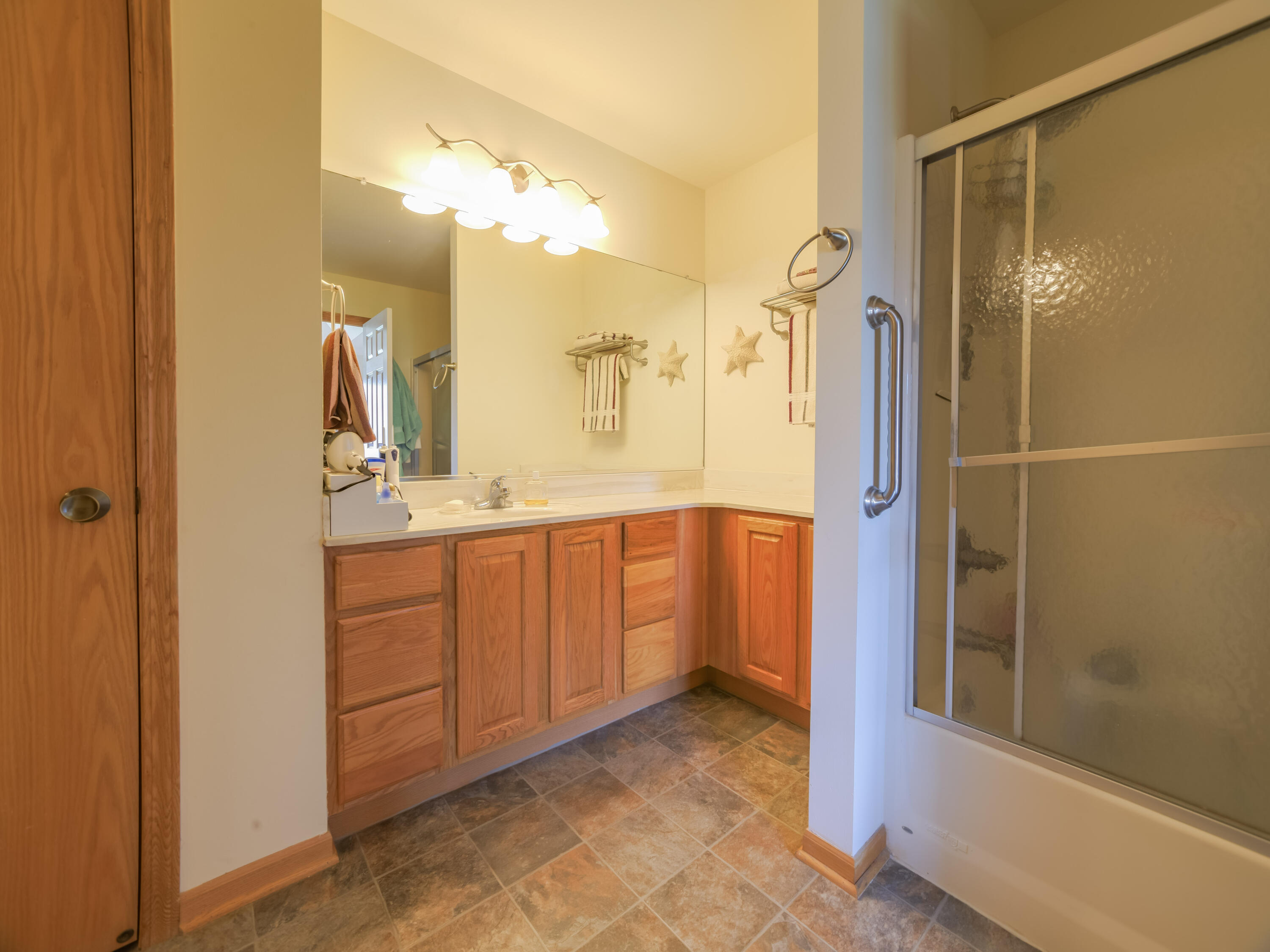 10123 Azalea Drive Crown Point, IN 46307 - Photo 23 of 32 a bathroom with a double vanity sink a mirror and shower