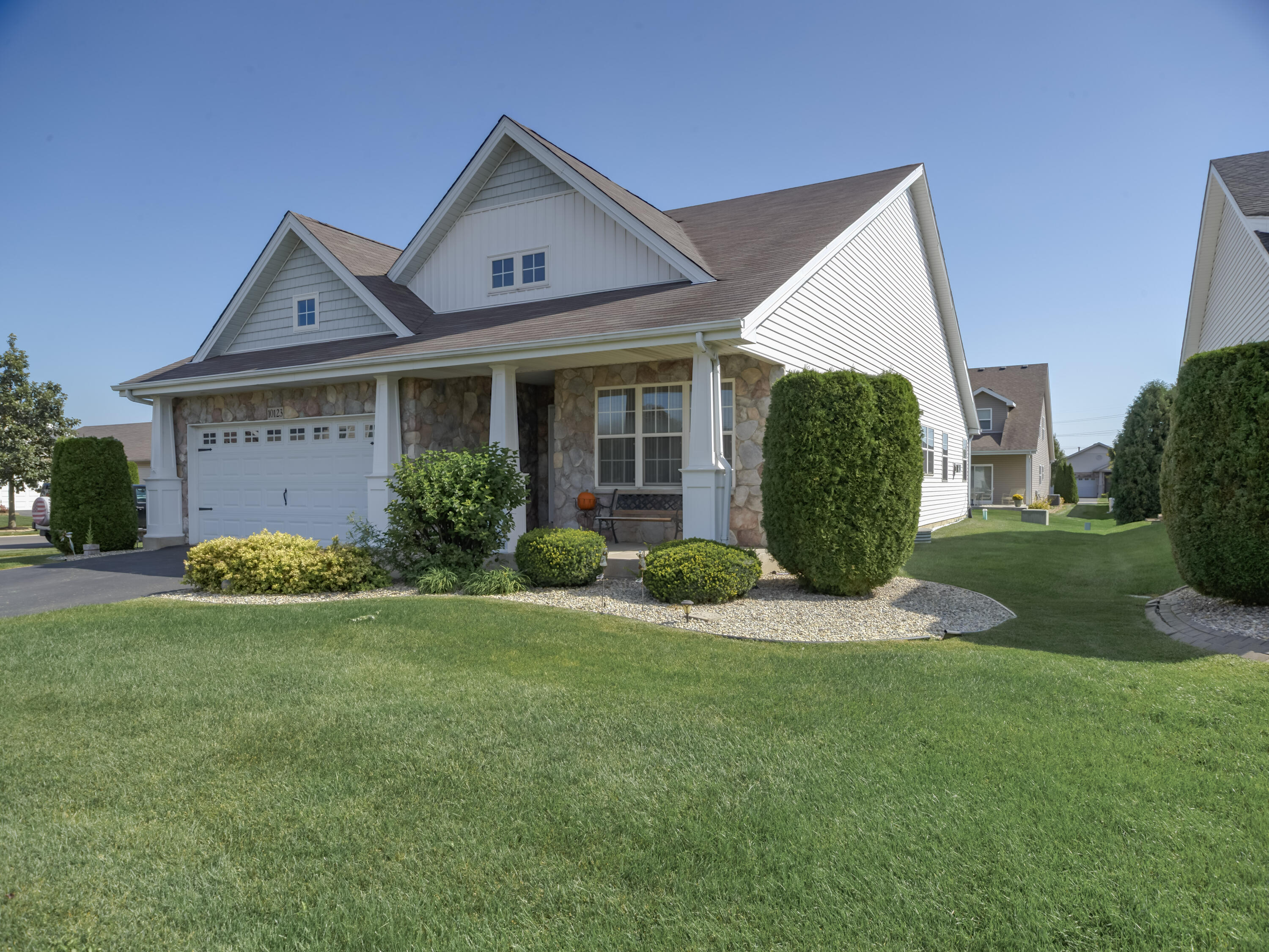 10123 Azalea Drive Crown Point, IN 46307 - Photo 3 of 32 a front view of a house with a garden and plants