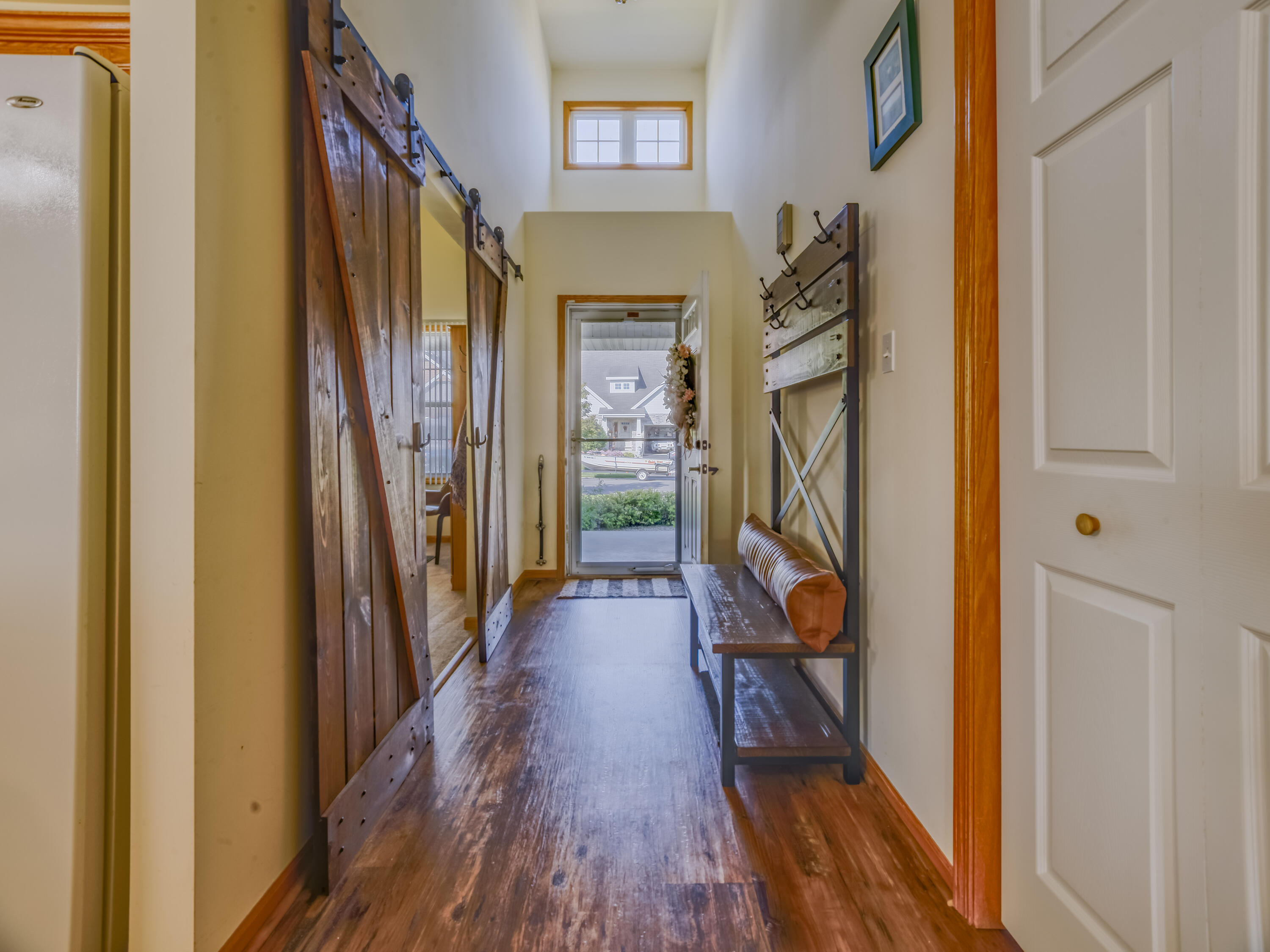 10123 Azalea Drive Crown Point, IN 46307 - Photo 4 of 32 a view of a hallway with wooden floor and stairs