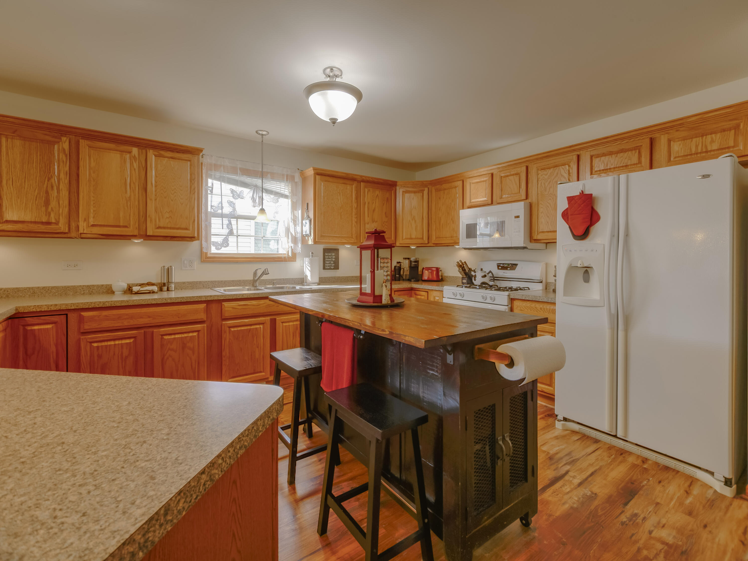 10123 Azalea Drive Crown Point, IN 46307 - Photo 8 of 32 a kitchen with stainless steel appliances granite countertop a sink a refrigerator and a stove