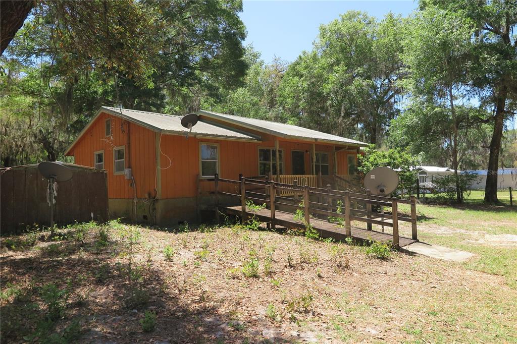 a backyard of a house with wooden fence and trees