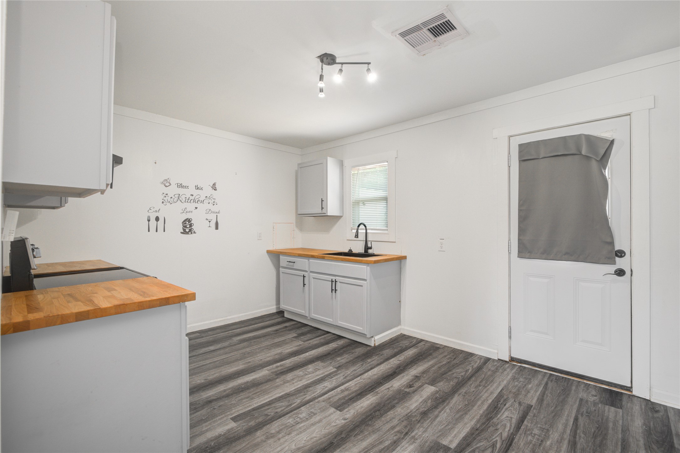 609 Hurst Place Angleton, TX 77515 - Photo 12 of 36 a kitchen with sink cabinets and wooden floor