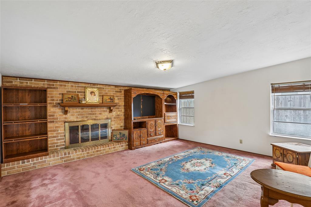 1810 Ridgewood Street Irving, TX 75062 - Photo 8 of 19 From the dining room to the den w/ cozy fireplace.
