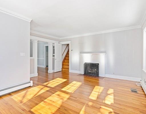 27 Elsworth Road Newton, MA 02465 - Photo 7 of 14 a view of a livingroom with wooden floor and a fireplace