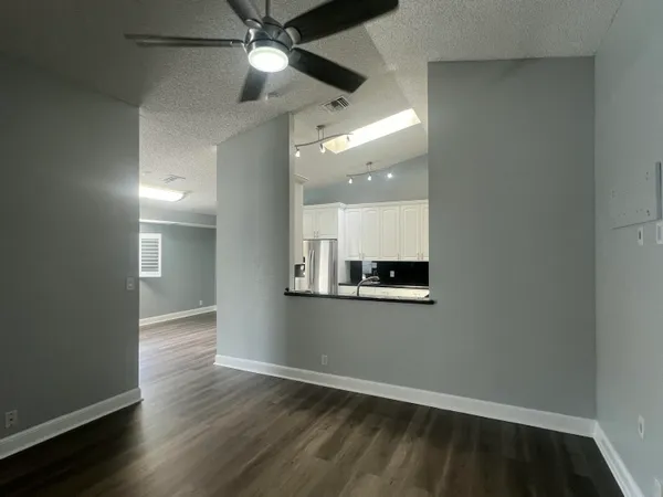 a kitchen with granite countertop a stove microwave and sink
