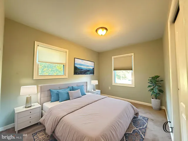 a bedroom with a bed and a potted plant