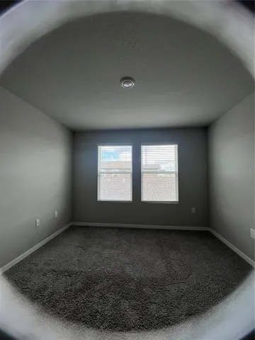 an empty room with a empty space and windows