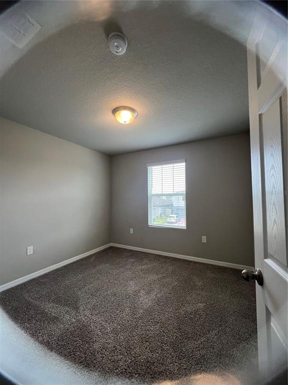 582 Amadoras Way St. Cloud, FL 34771 - Photo 17 of 22 an empty room with a empty space and windows