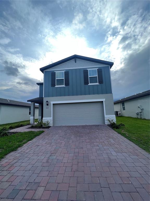 582 Amadoras Way St. Cloud, FL 34771 - Photo 20 of 22 a front view of a house with a yard