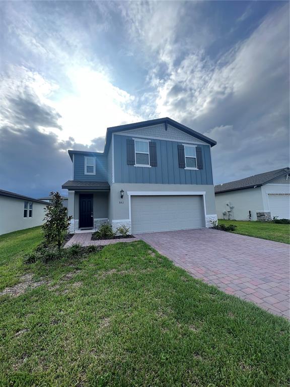 582 Amadoras Way St. Cloud, FL 34771 - Photo 21 of 22 a front view of a house with a yard and garage