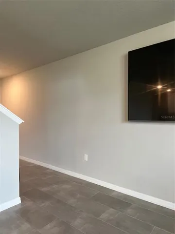 a view of an empty room with a flat screen tv