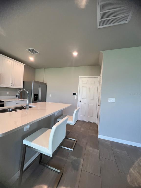 582 Amadoras Way St. Cloud, FL 34771 - Photo 8 of 22 a large kitchen with a table and chairs