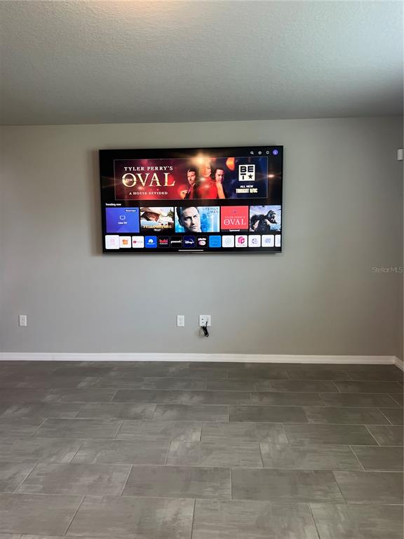 582 Amadoras Way St. Cloud, FL 34771 - Photo 9 of 22 a room with a projector and screen