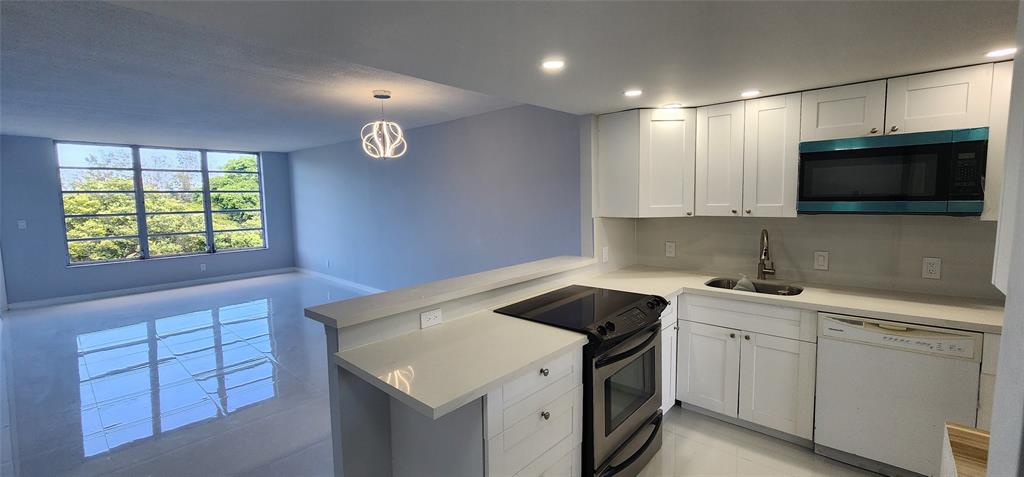 a kitchen that has a sink and a stove in it