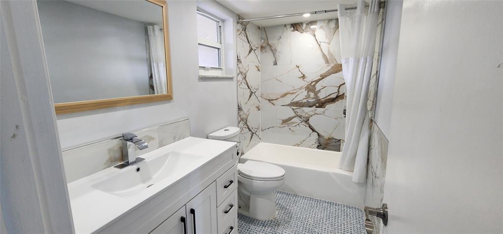 2650 South Course Drive, Unit 505 Pompano Beach, FL 33069 - Photo 11 of 42 a bathroom with a sink a toilet and shower