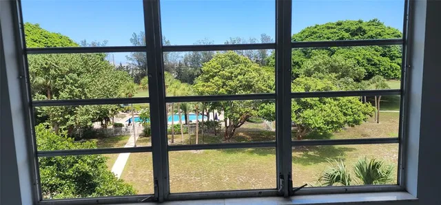 an empty room with windows and view of an empty room