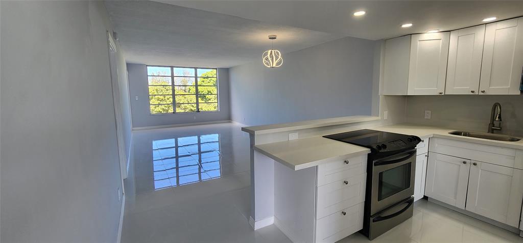 2650 South Course Drive, Unit 505 Pompano Beach, FL 33069 - Photo 2 of 42 a kitchen with a stove and a sink