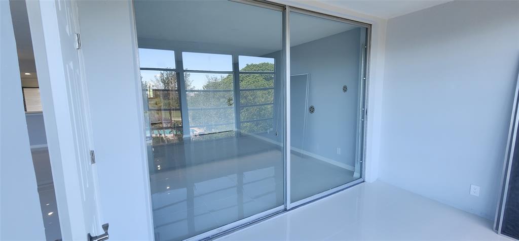2650 South Course Drive, Unit 505 Pompano Beach, FL 33069 - Photo 24 of 42 a bathroom with a glass shower door