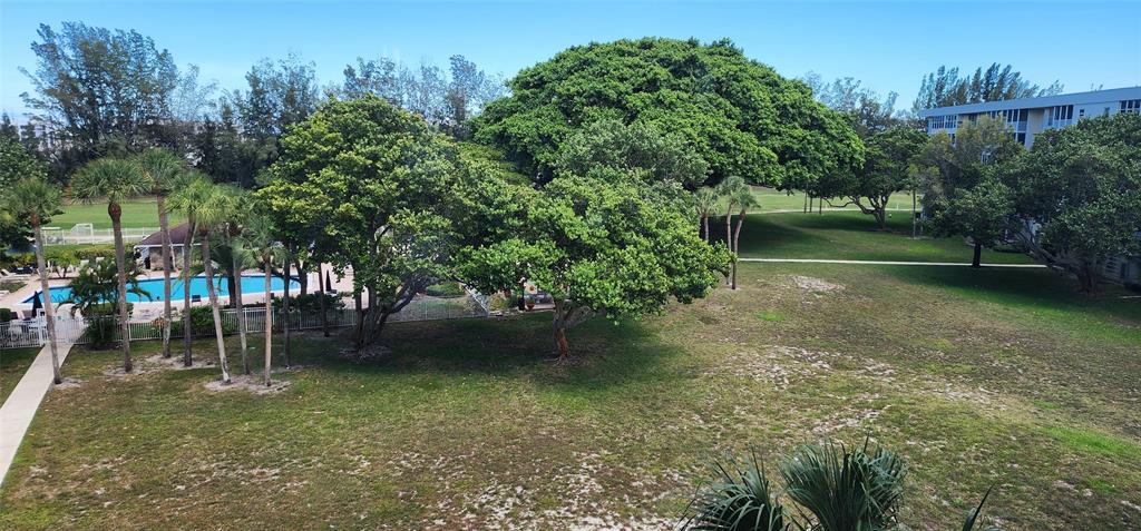 2650 South Course Drive, Unit 505 Pompano Beach, FL 33069 - Photo 31 of 42 a backyard of a house with lots of green space