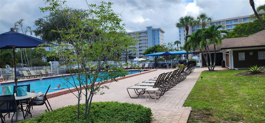 2650 South Course Drive, Unit 505 Pompano Beach, FL 33069 - Photo 35 of 42 a view of swimming pool with a patio and a garden