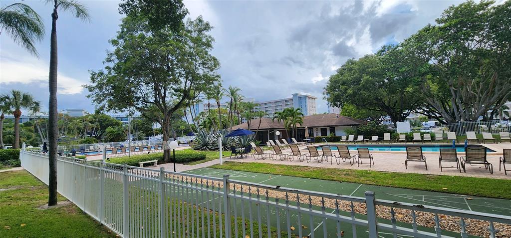 2650 South Course Drive, Unit 505 Pompano Beach, FL 33069 - Photo 37 of 42 a view of a house with a yard table and chairs