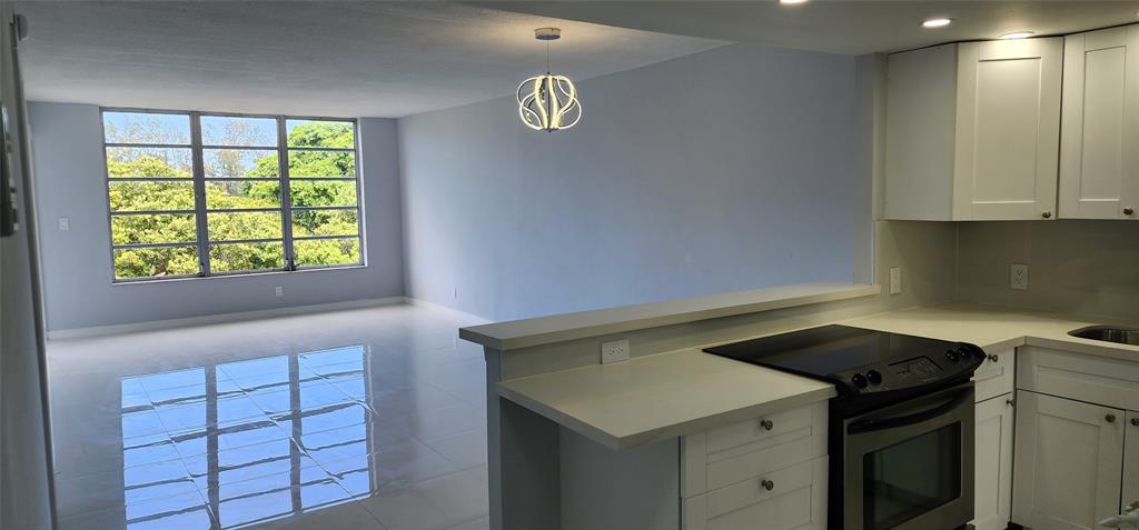 2650 South Course Drive, Unit 505 Pompano Beach, FL 33069 - Photo 4 of 42 a utility room with windows and cabinet