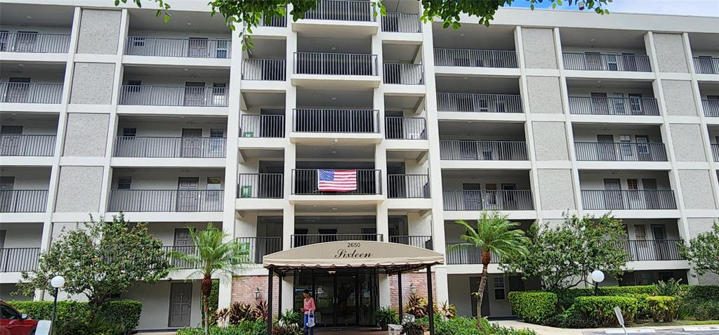 2650 South Course Drive, Unit 505 Pompano Beach, FL 33069 - Photo 42 of 42 a view of a building with a large window and plants