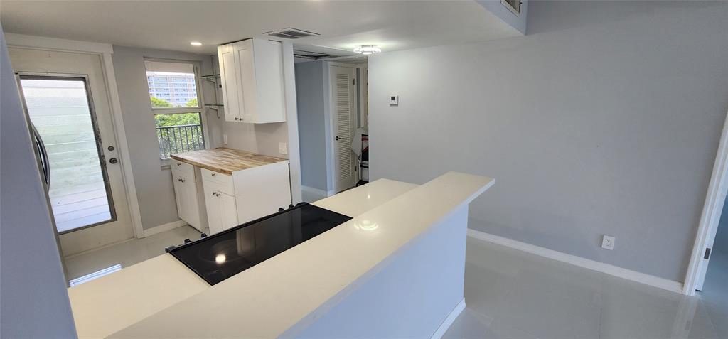 2650 South Course Drive, Unit 505 Pompano Beach, FL 33069 - Photo 6 of 42 a living room with furniture and a gate