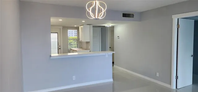 a spacious bathroom with a bathtub and a chandelier