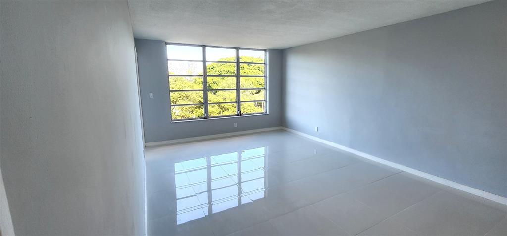 2650 South Course Drive, Unit 505 Pompano Beach, FL 33069 - Photo 8 of 42 an empty room with windows