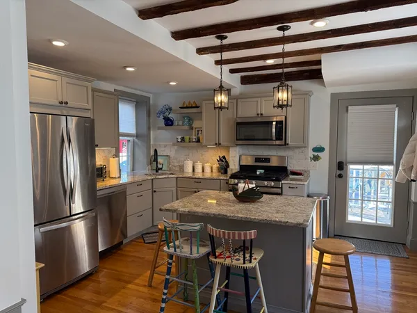 a kitchen with stainless steel appliances a refrigerator a stove a sink and a microwave