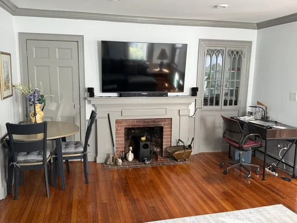 a living room with furniture fireplace and flat screen tv
