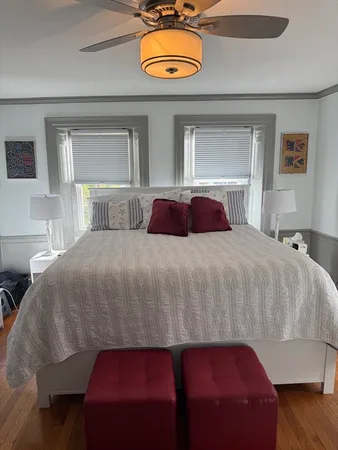 a bedroom with a bed and a potted plant