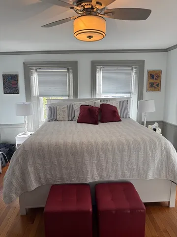 a bedroom with a bed and a potted plant