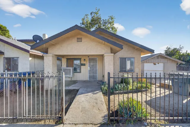 a view of a house with a patio and a garden