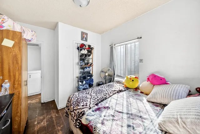 a bedroom with two bed and a window