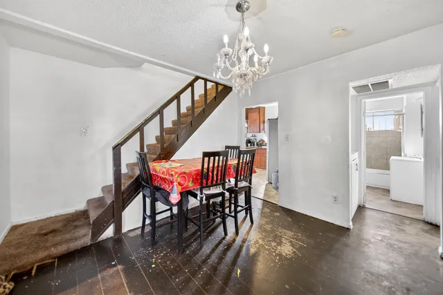 a dining room with furniture entryway and wooden floor