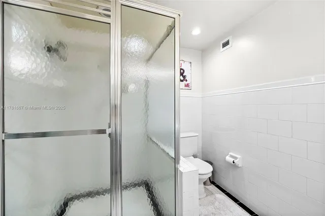 a bathroom with a shower and a toilet