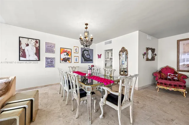 a view of a dining room with furniture and chandelier