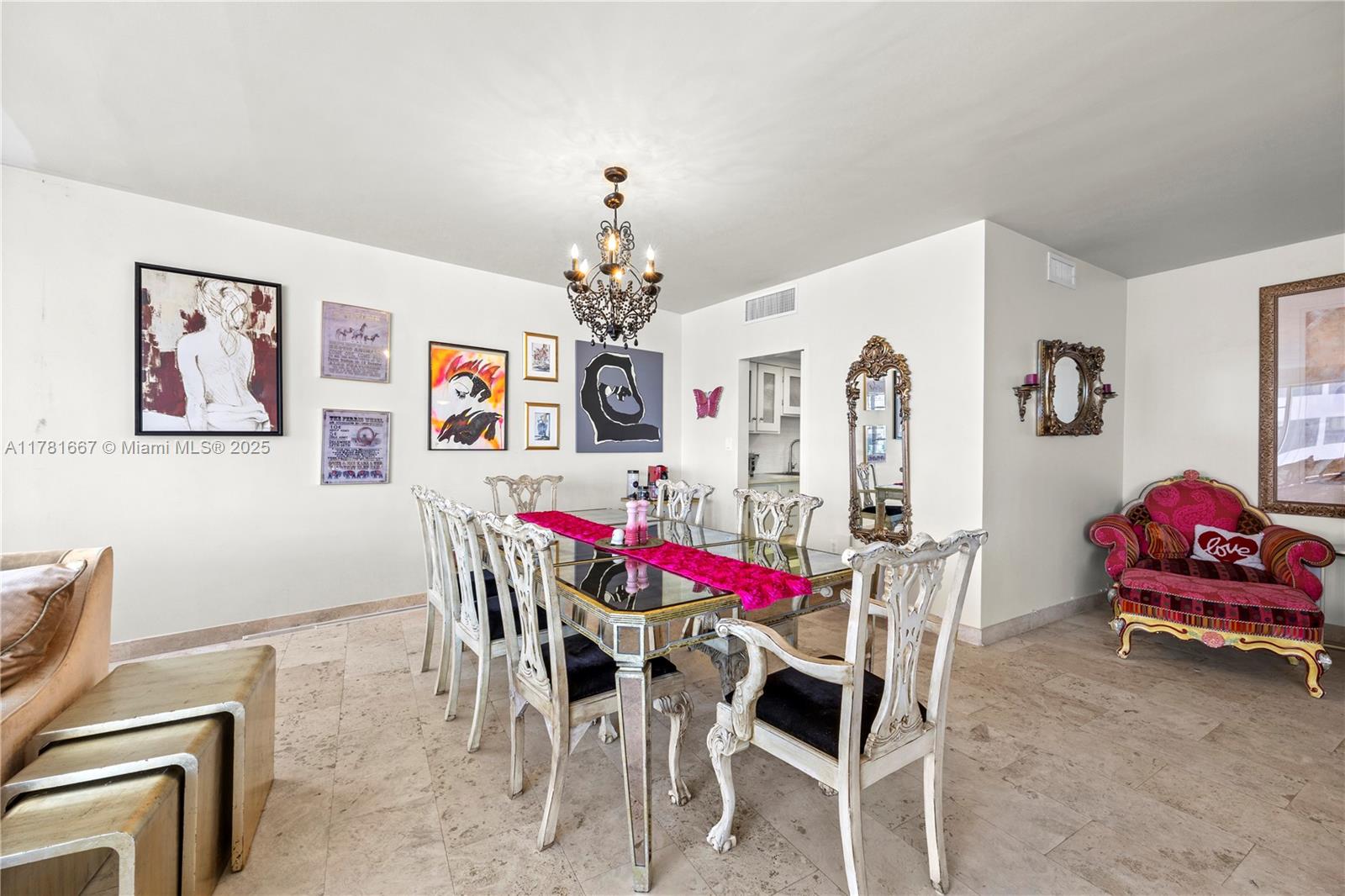 5255 Collins Avenue, Unit 11A Miami Beach, FL 33140 - Photo 3 of 15 a view of a dining room with furniture and chandelier