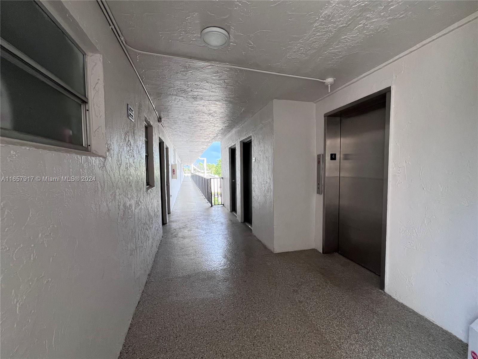 14165 Southwest 87th Street, Unit D404 Miami, FL 33183 - Photo 19 of 25 4th floor elevator