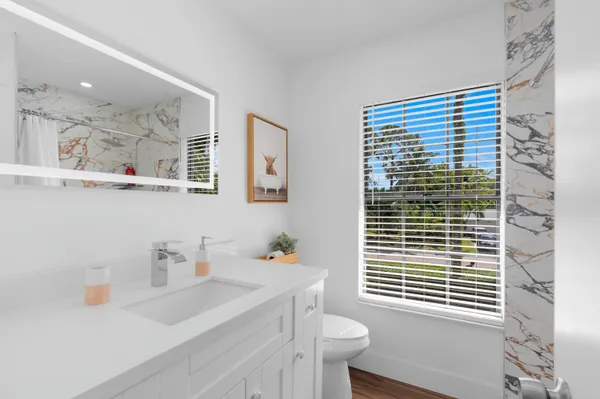 a bathroom with a sink a toilet and a shower