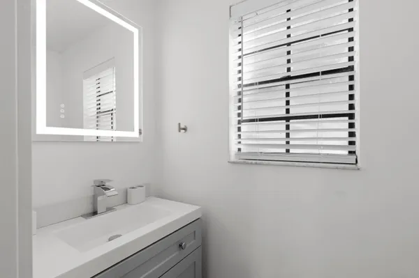 a bathroom with a sink and a window